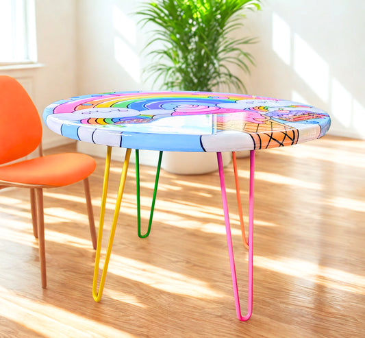 Whimsical rainbow epoxy kids table for playrooms, nurseries, or living rooms — hand-painted, functional art for colorful home decor and gifting.